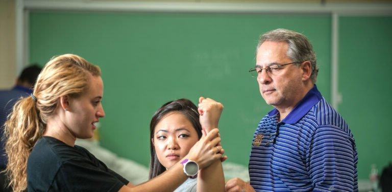 Physical Therapy student demonstrating her knowledge to the professor